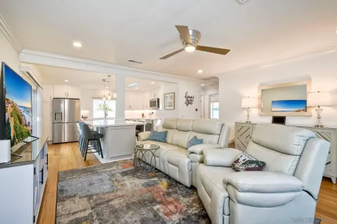 a living room with furniture a large window and a flat screen tv