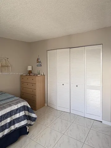 a bedroom with a bed and a cabinets