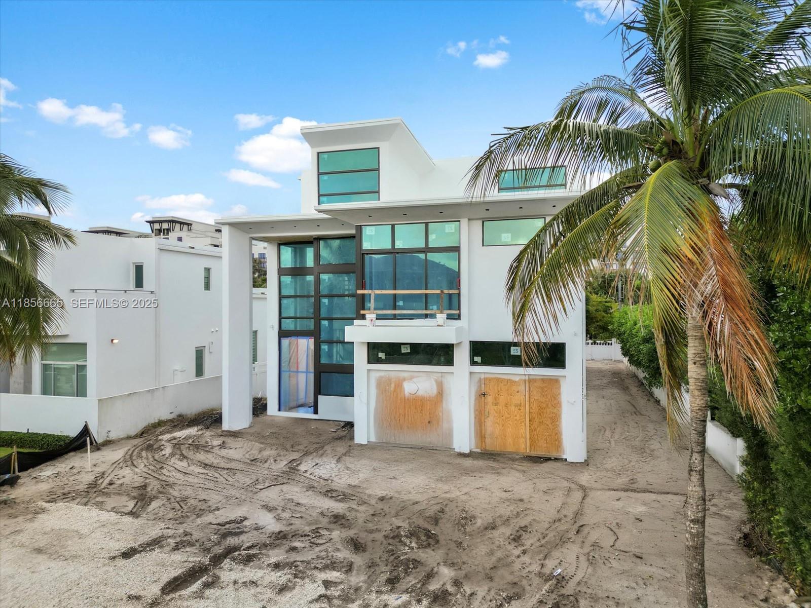 344 Northeast 2nd Street Boca Raton, FL 33432 - Photo 2 of 12 a view of a house with a backyard and a palm tree
