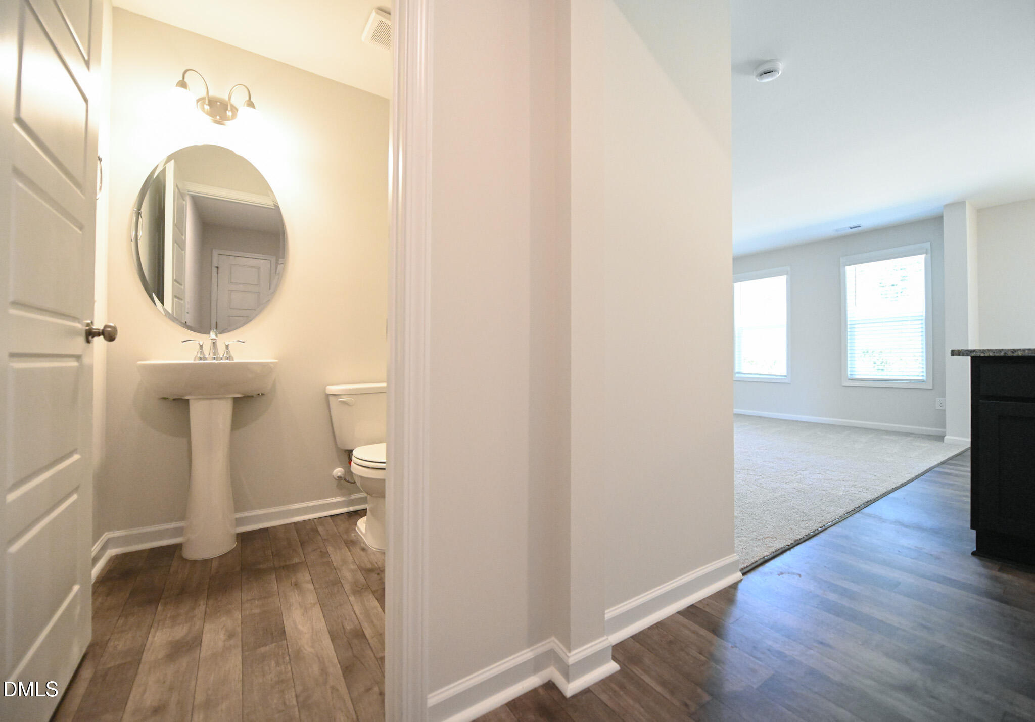 2009 Black Bear Court, Unit (LOT 5) Hope Mills, NC 28348 - Photo 15 of 29 a view of a hallway with wooden floor and a bathroom