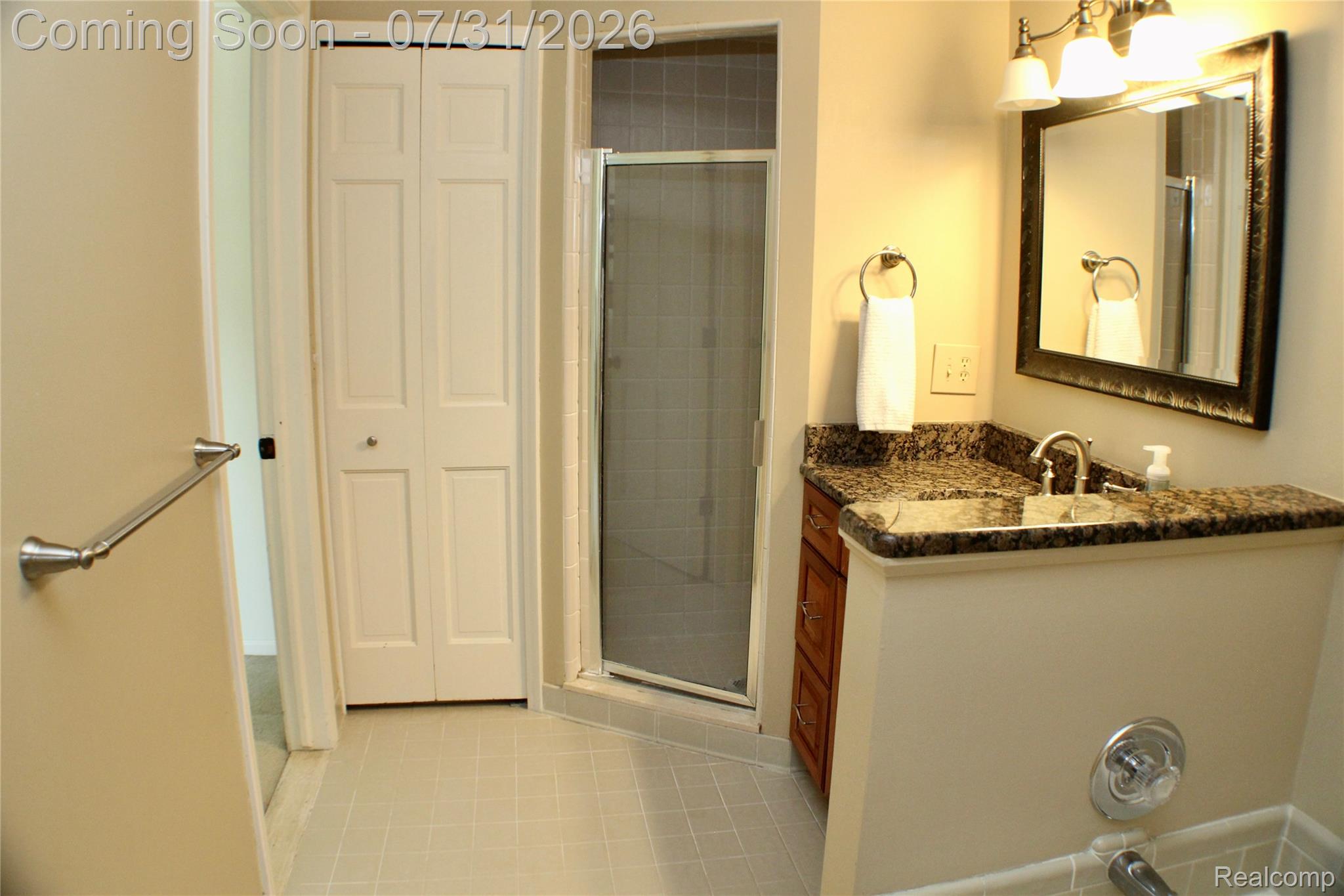 362 Lake Forest Road Rochester, MI 48309 - Photo 30 of 50 Bathroom featuring a vanity with a dark speckled countertop, undermount sink, and chrome faucet