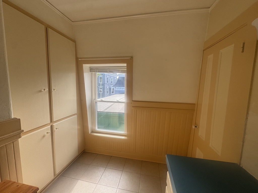39 Belmont Street, Unit 2 Fall River, MA 02720 - Photo 9 of 10 a view of a small space with wooden floor and a window
