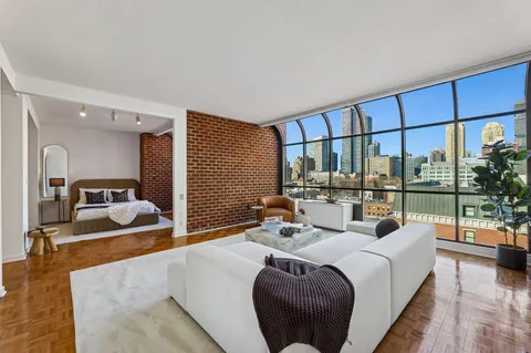 a bedroom with furniture and a large window