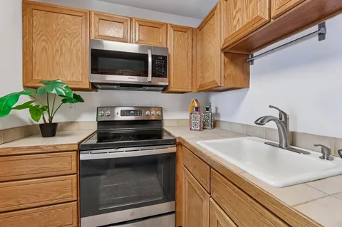 a kitchen with a sink a stove and microwave