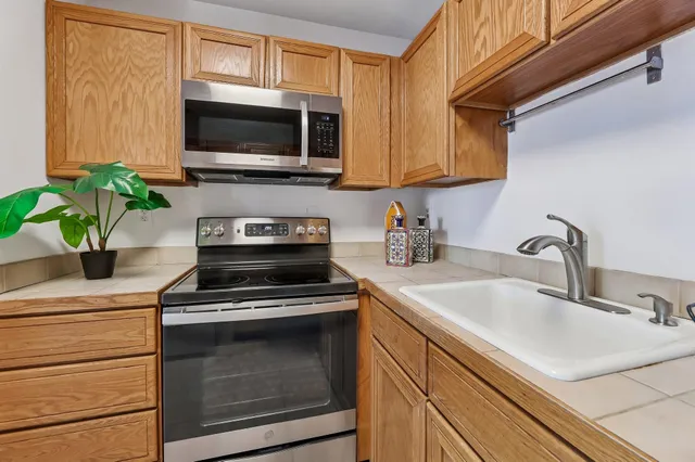 a kitchen with a sink a stove and microwave