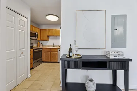 a kitchen with a sink a stove cabinets and a dining table