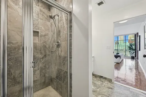 a bathroom with a shower and a window