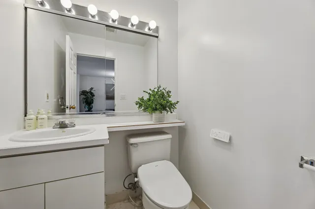 a bathroom with a toilet sink and mirror