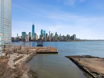a view of a lake with tall buildings