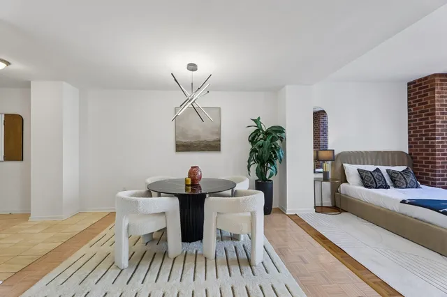 a living room with furniture and a potted plant