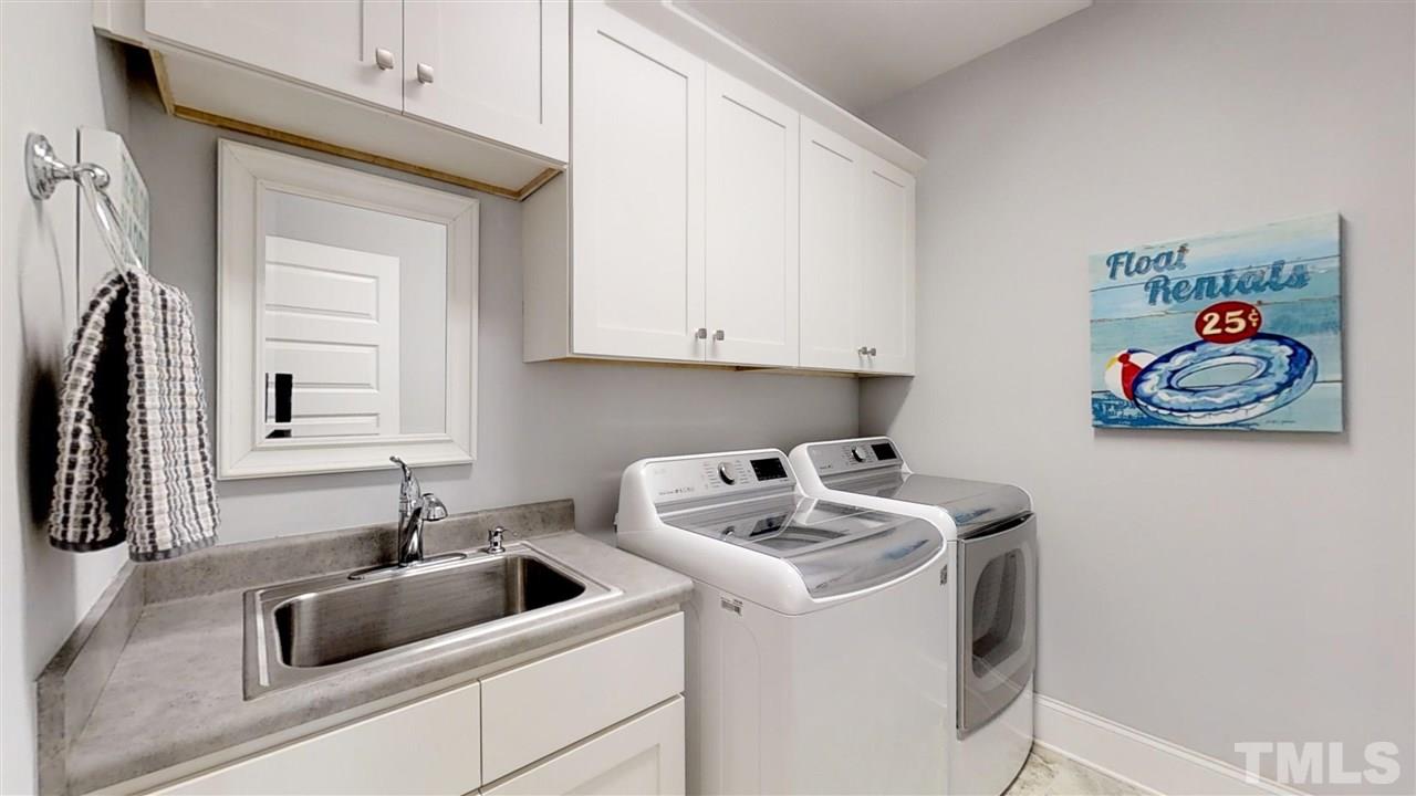 3128 Constance Circle Raleigh, NC 27603 - Photo 13 of 25 a kitchen with a sink a stove and cabinets