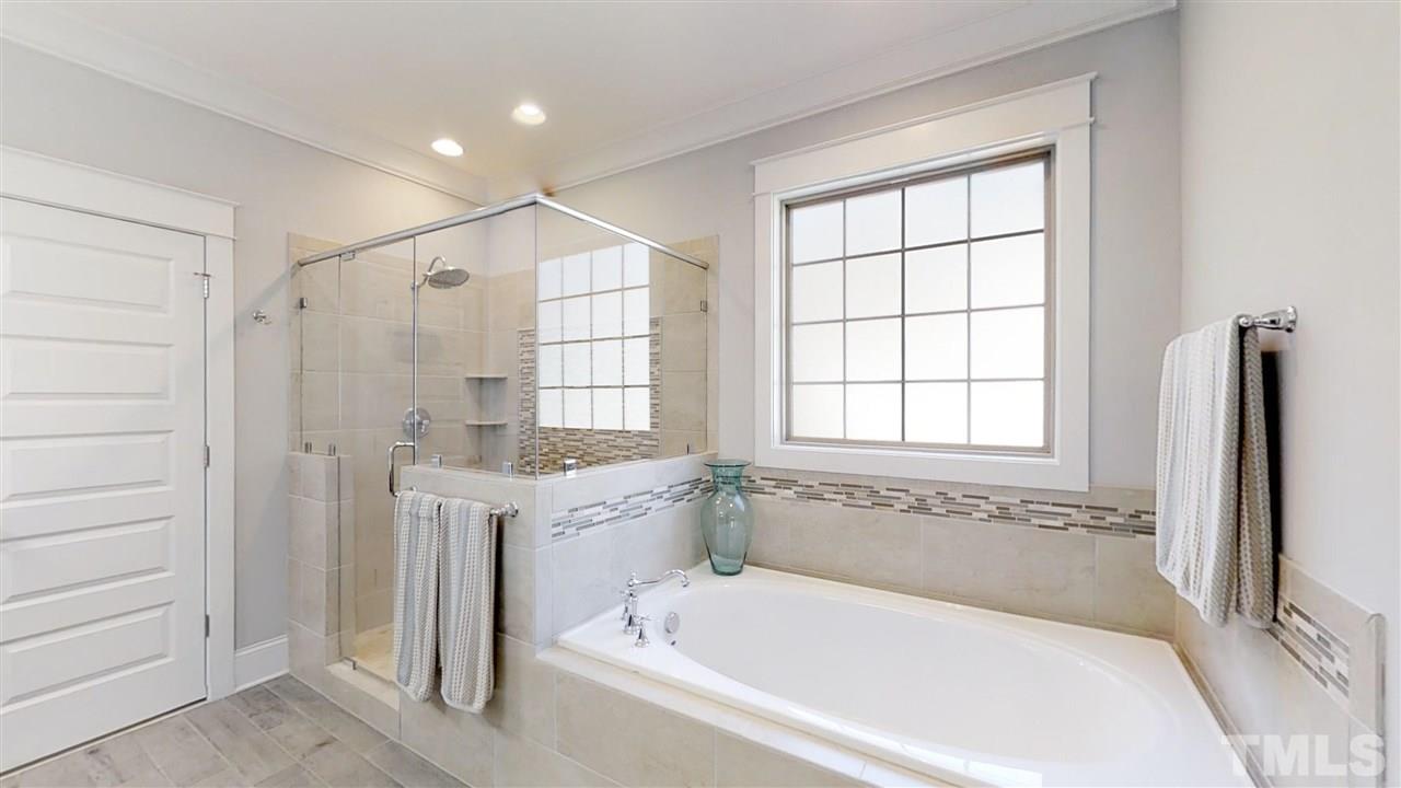 3128 Constance Circle Raleigh, NC 27603 - Photo 17 of 25 a spacious bathroom with a bathtub and a shower