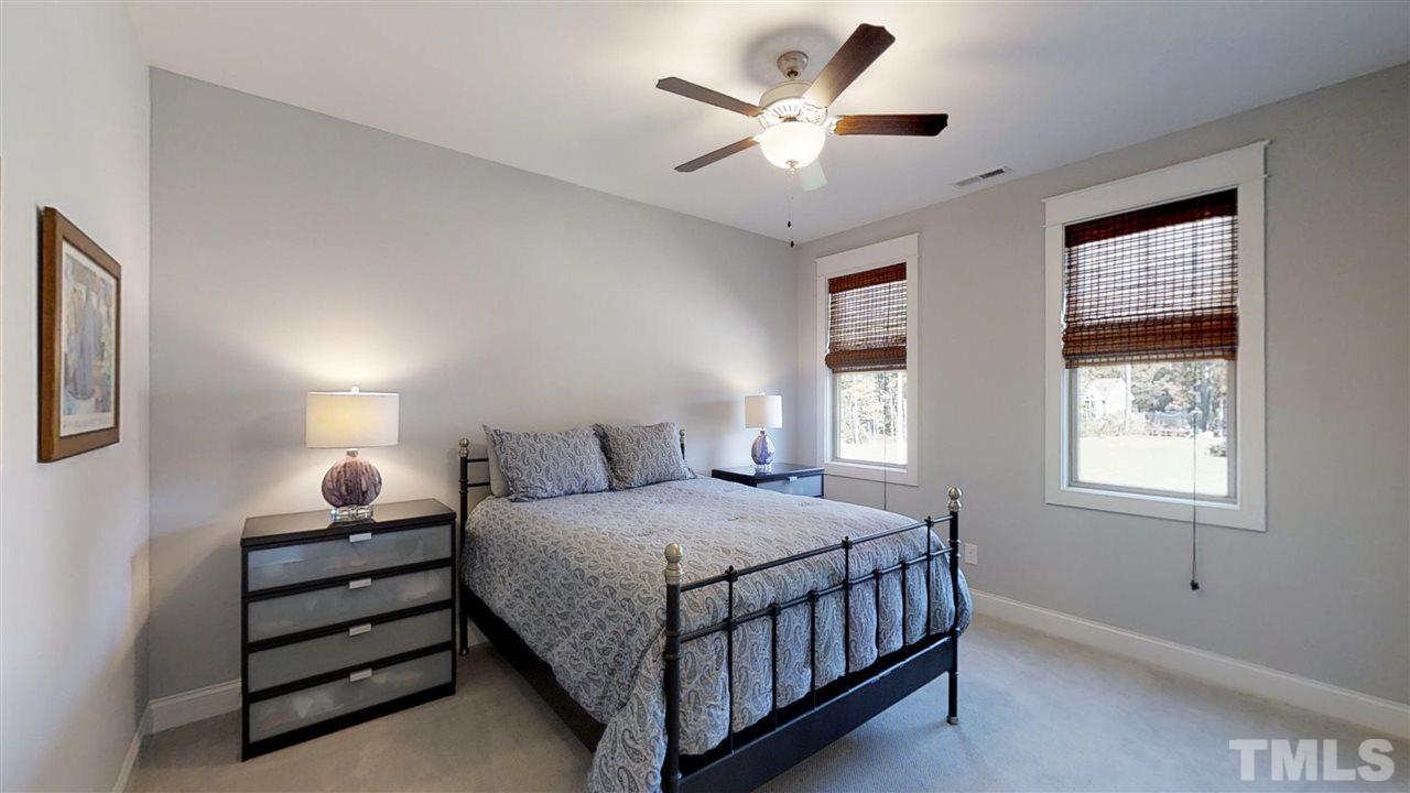 3128 Constance Circle Raleigh, NC 27603 - Photo 20 of 25 a bedroom with a bed chandelier and a window