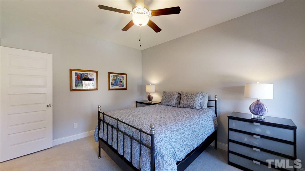 3128 Constance Circle Raleigh, NC 27603 - Photo 21 of 25 a bedroom with a bed and a chandelier