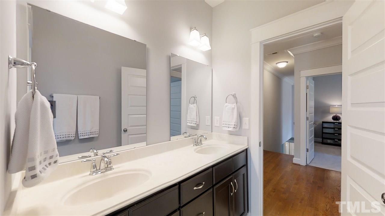 3128 Constance Circle Raleigh, NC 27603 - Photo 23 of 25 a bathroom with a sink double vanity and a mirror