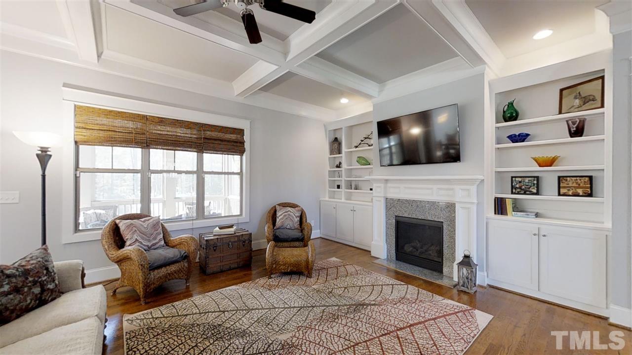 3128 Constance Circle Raleigh, NC 27603 - Photo 6 of 25 a living room with furniture a flat screen tv and a fireplace