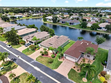 an aerial view of a house with garden space and lake view