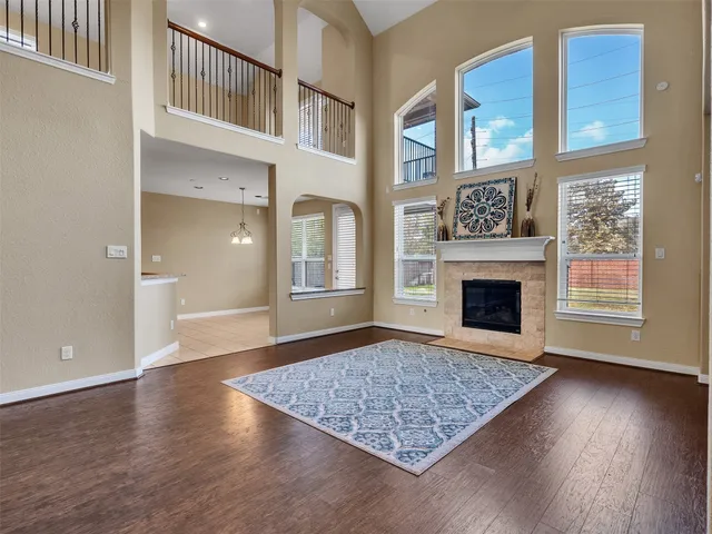 an empty room with windows and fireplace