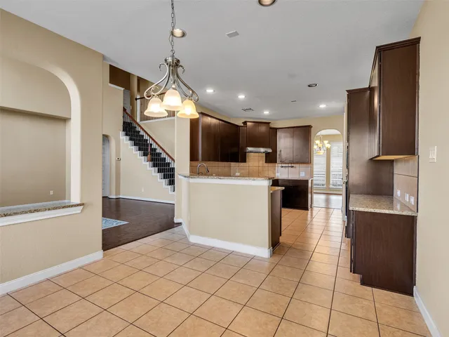 a view of a kitchen with cabinets and stainless steel appliances