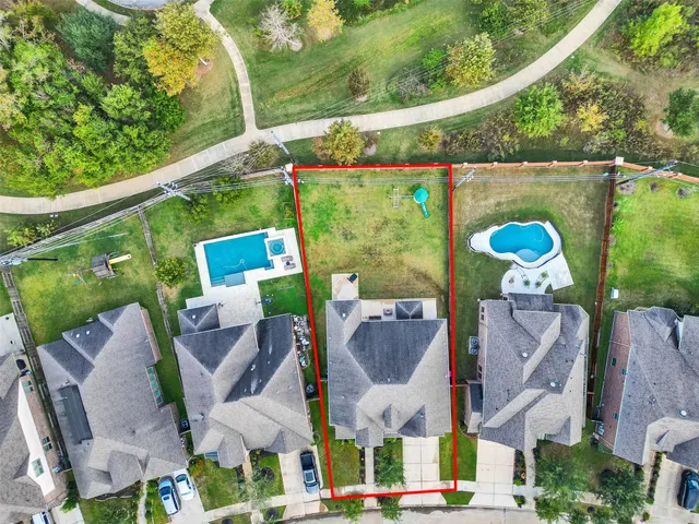 an aerial view of a house with swimming pool and outdoor seating