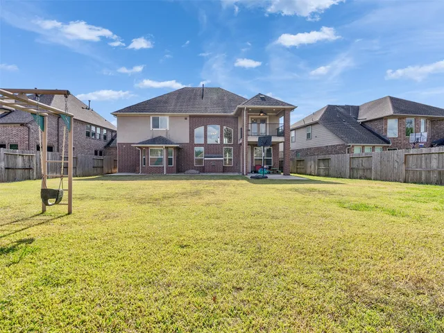 a house view with swimming pool in front of it
