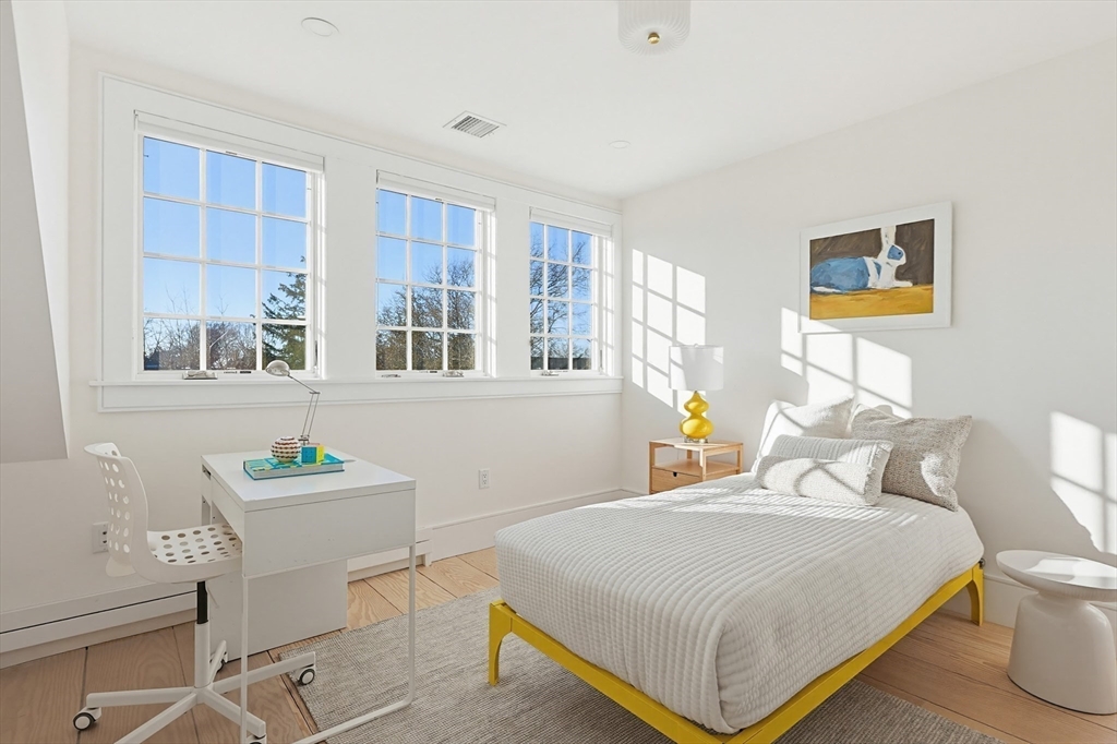 102 Fuller Street, Unit 2 Brookline, MA 02446 - Photo 12 of 27 a bedroom with a bed and a table in it