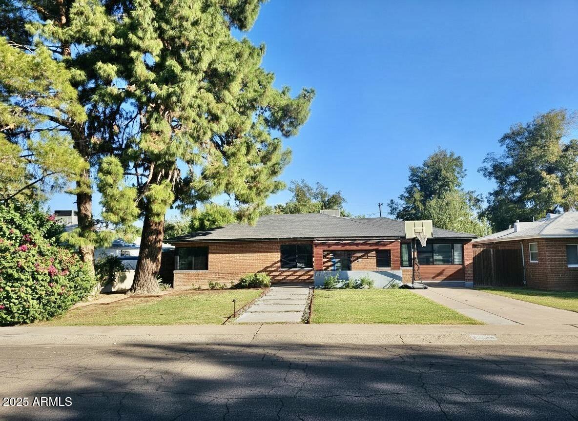 1520 West Berridge Lane Phoenix, AZ 85015 - Photo 1 of 46 front view of a house with a yard
