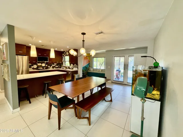 a living room with stainless steel appliances kitchen island granite countertop furniture and a view of kitchen