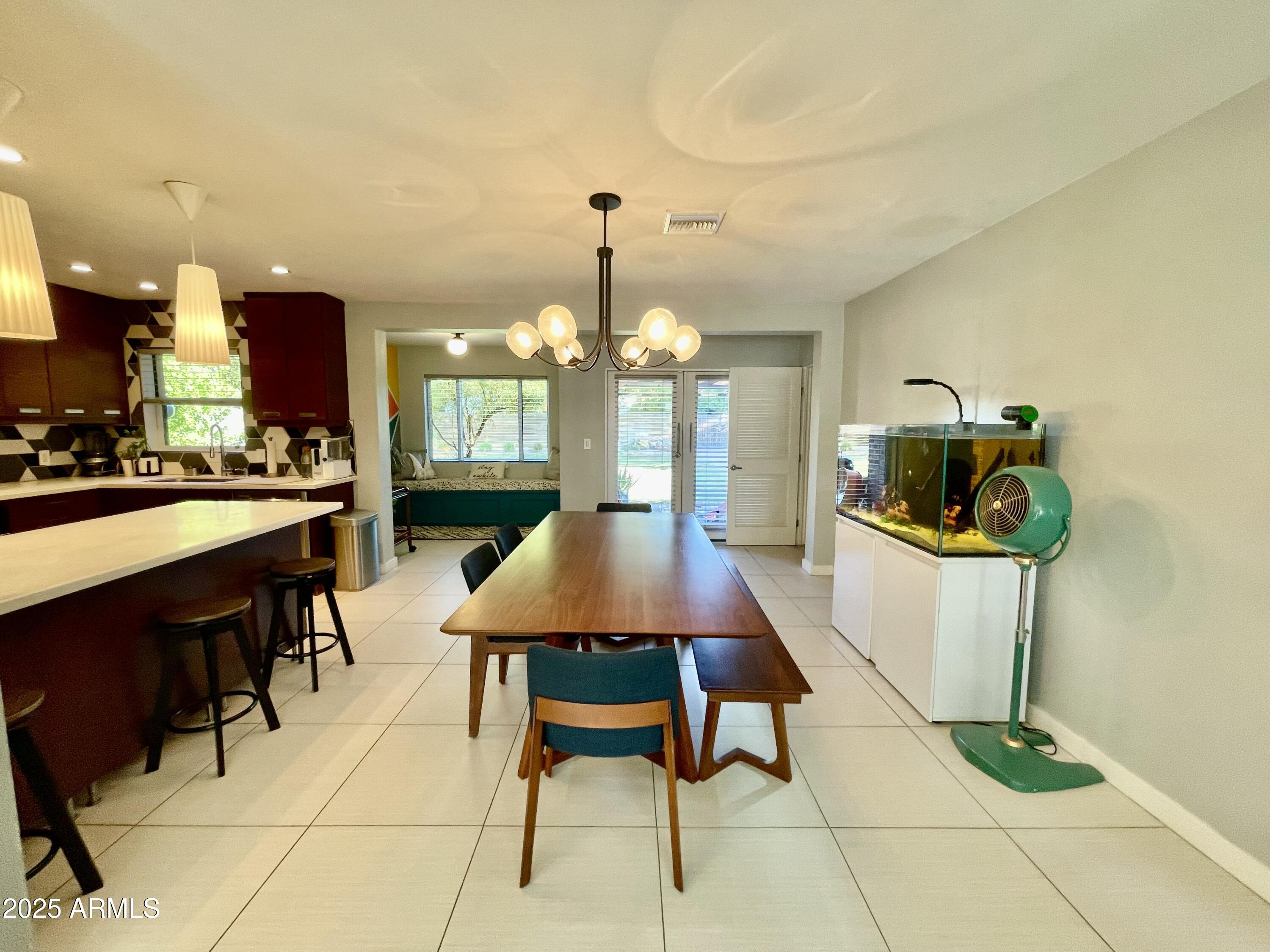 1520 West Berridge Lane Phoenix, AZ 85015 - Photo 15 of 46 a view of a dining room with furniture and chandelier