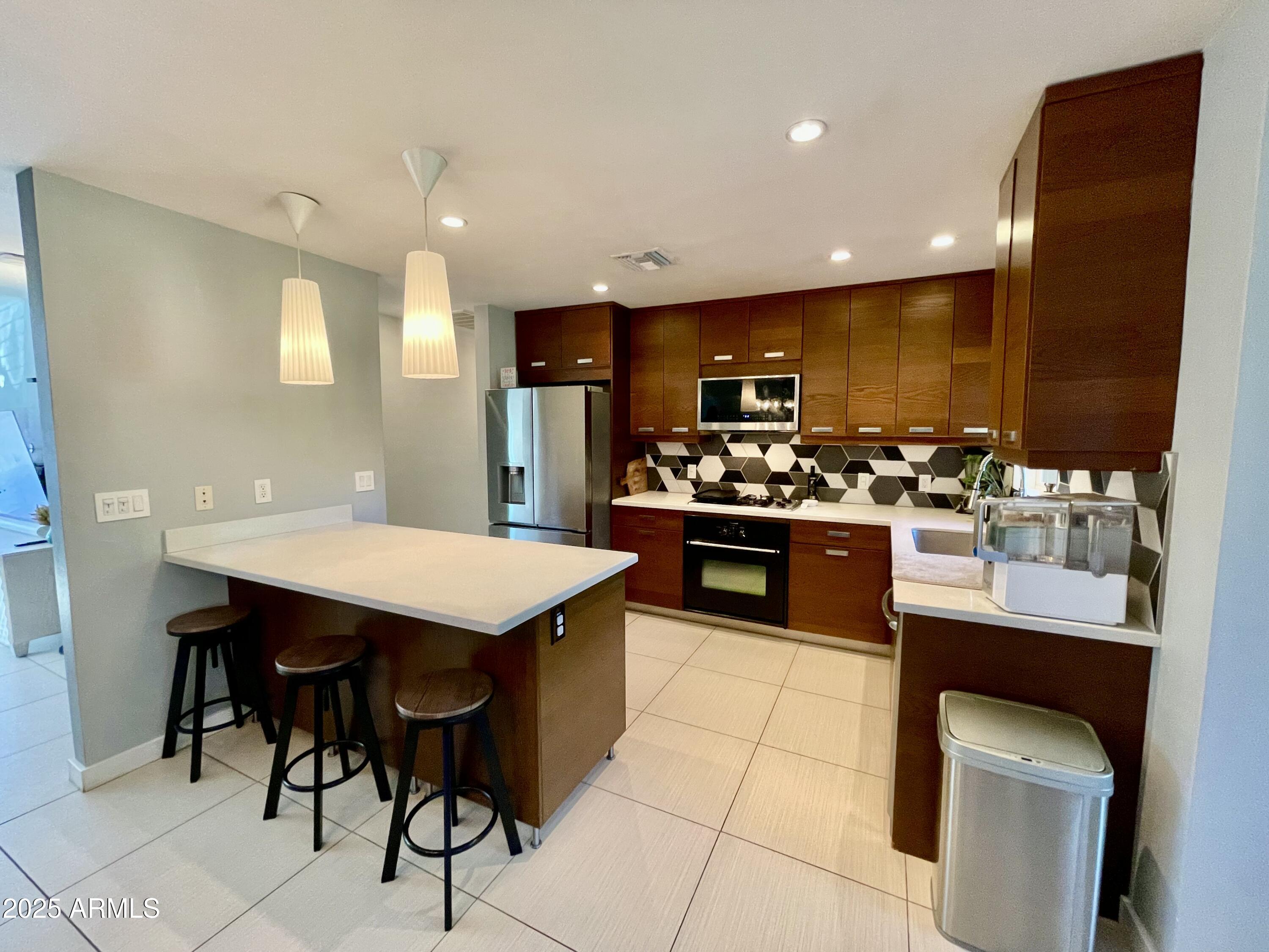 1520 West Berridge Lane Phoenix, AZ 85015 - Photo 16 of 46 a kitchen with stainless steel appliances granite countertop a stove a sink dishwasher and a refrigerator