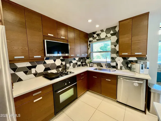 a kitchen with a sink stove and cabinets