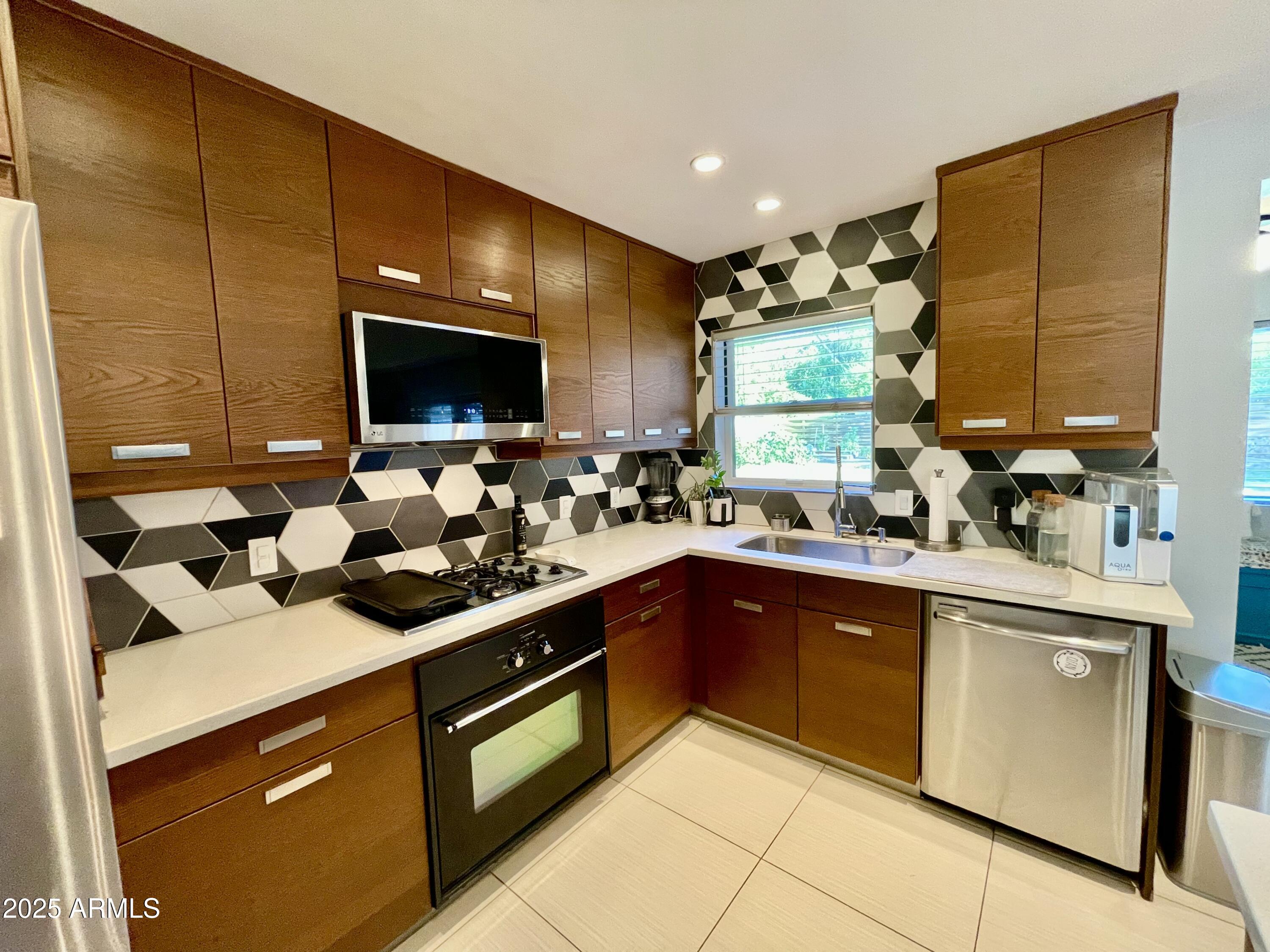 1520 West Berridge Lane Phoenix, AZ 85015 - Photo 19 of 46 a kitchen with a sink stove and cabinets