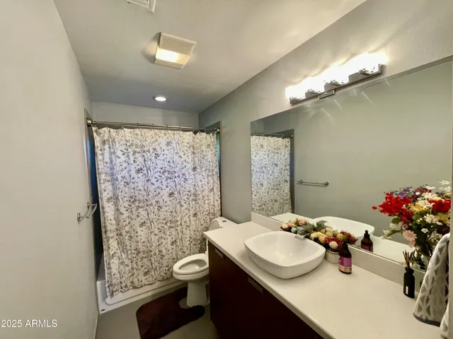 a bathroom with a sink mirror and vanity
