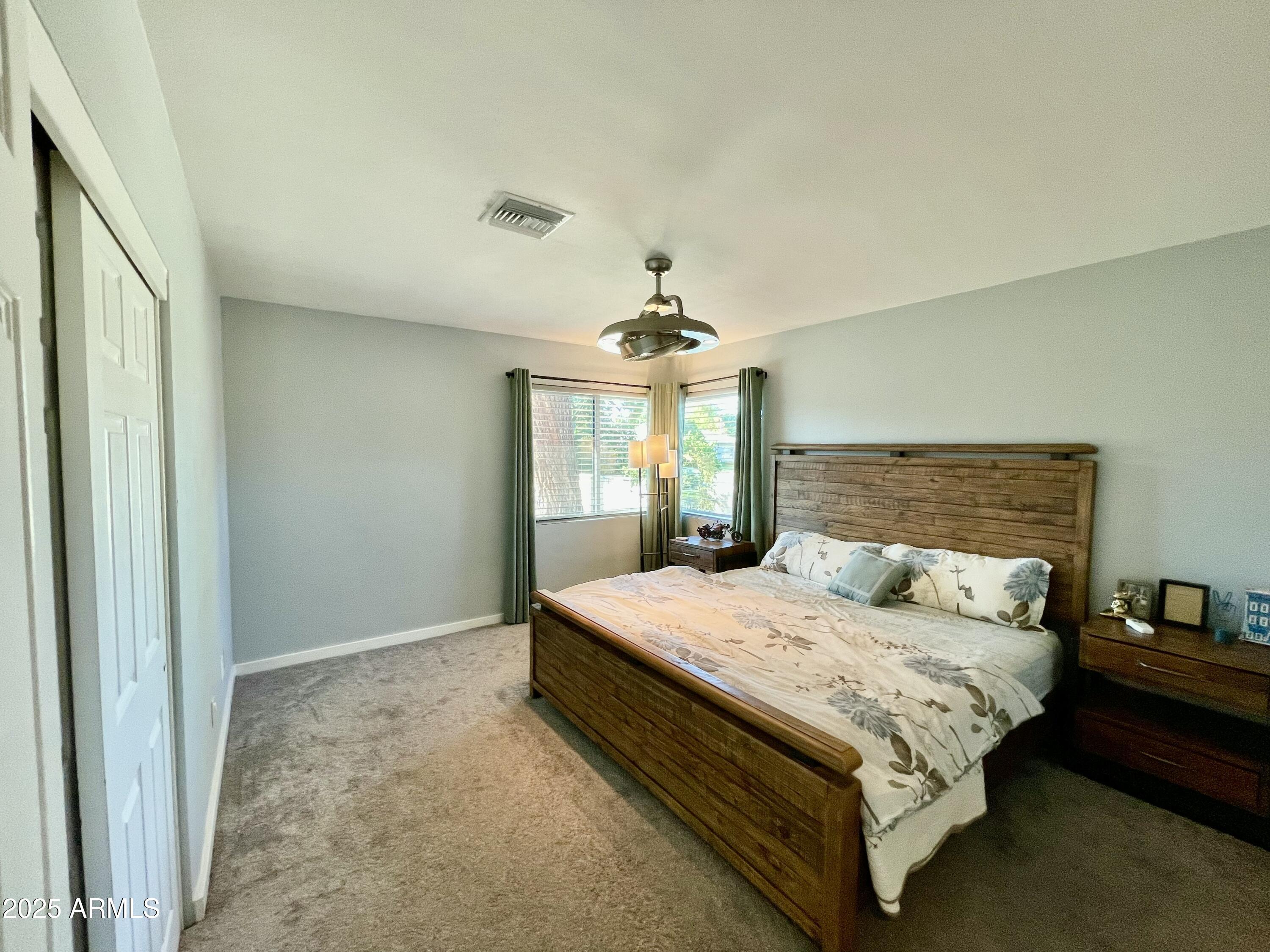 1520 West Berridge Lane Phoenix, AZ 85015 - Photo 28 of 46 a bedroom with a large bed and a chandelier
