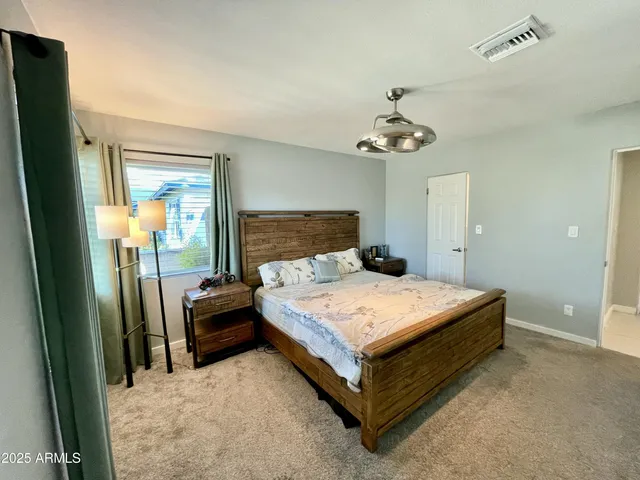 a bedroom with a bed and window