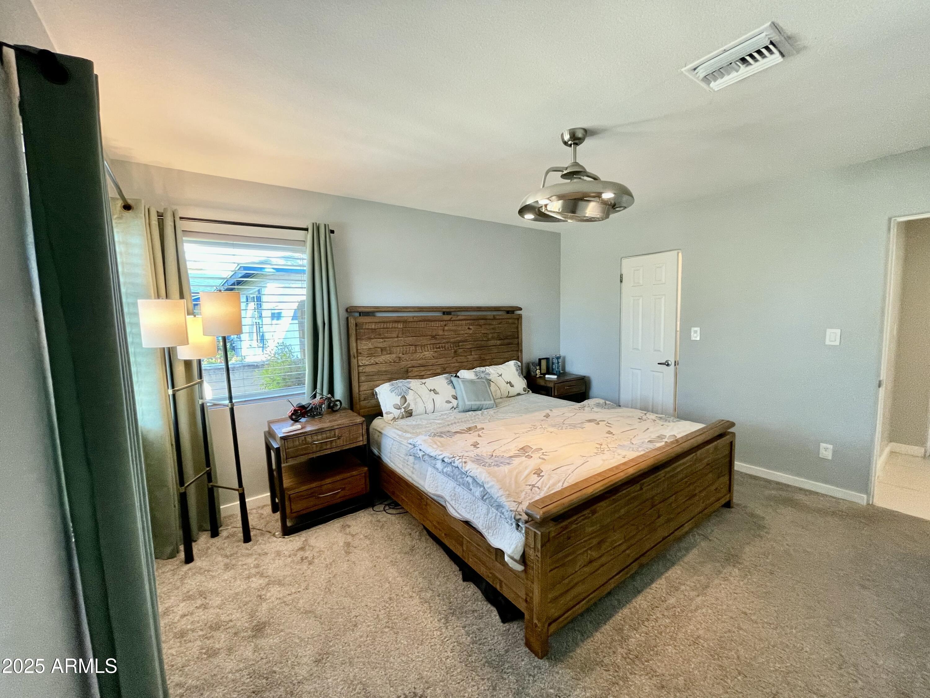 1520 West Berridge Lane Phoenix, AZ 85015 - Photo 29 of 46 a bedroom with a bed and window