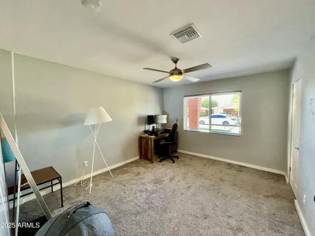 a room with furniture and a ceiling fan
