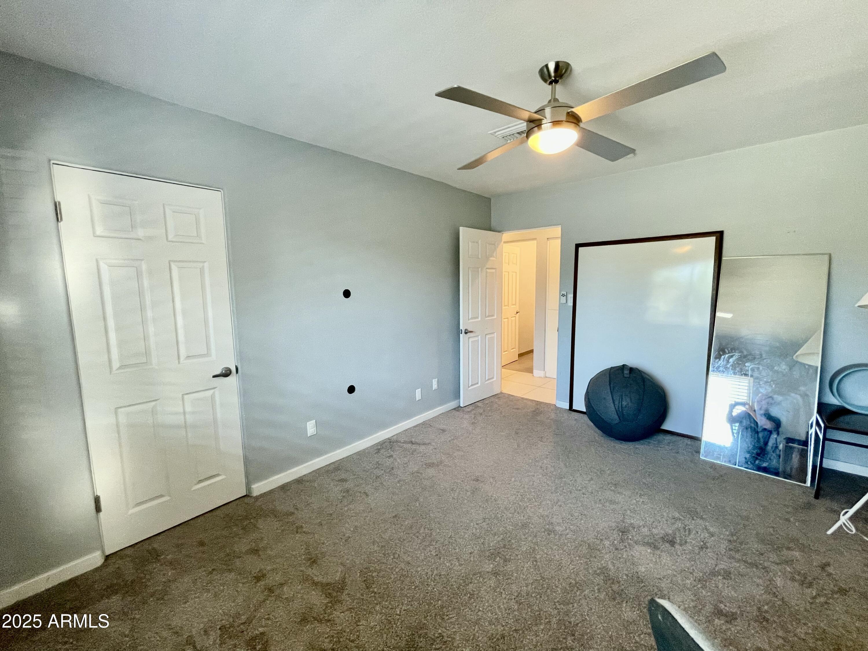 1520 West Berridge Lane Phoenix, AZ 85015 - Photo 36 of 46 a view of a livingroom with a ceiling fan and closet area