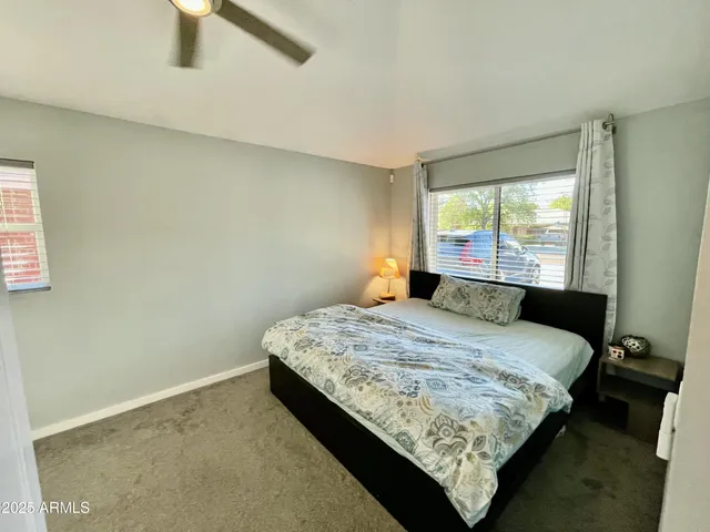 a bedroom with a bed lamp and window