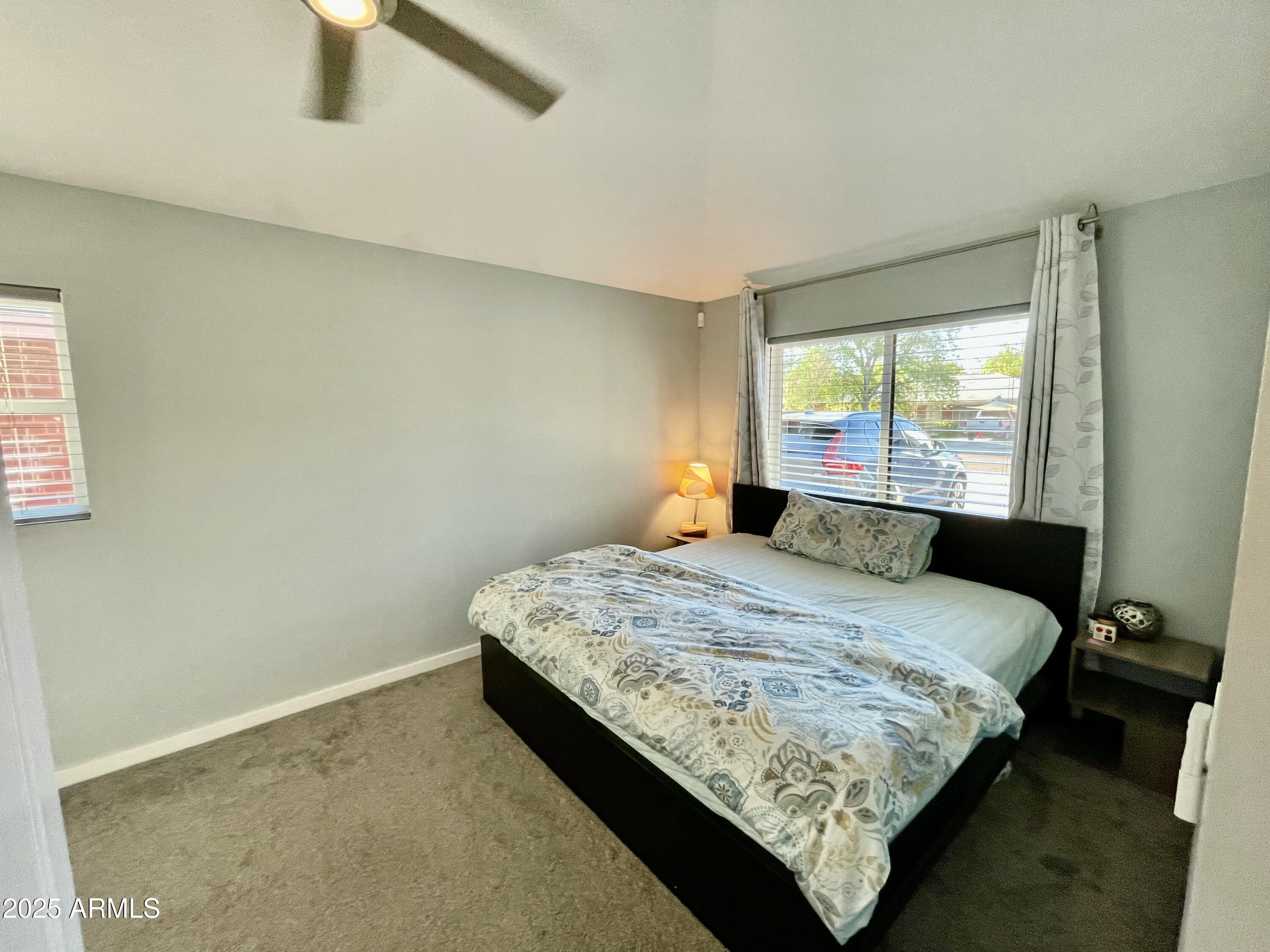 1520 West Berridge Lane Phoenix, AZ 85015 - Photo 38 of 46 a bedroom with a bed lamp and window