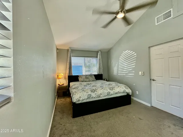 a bedroom with a bed and a window