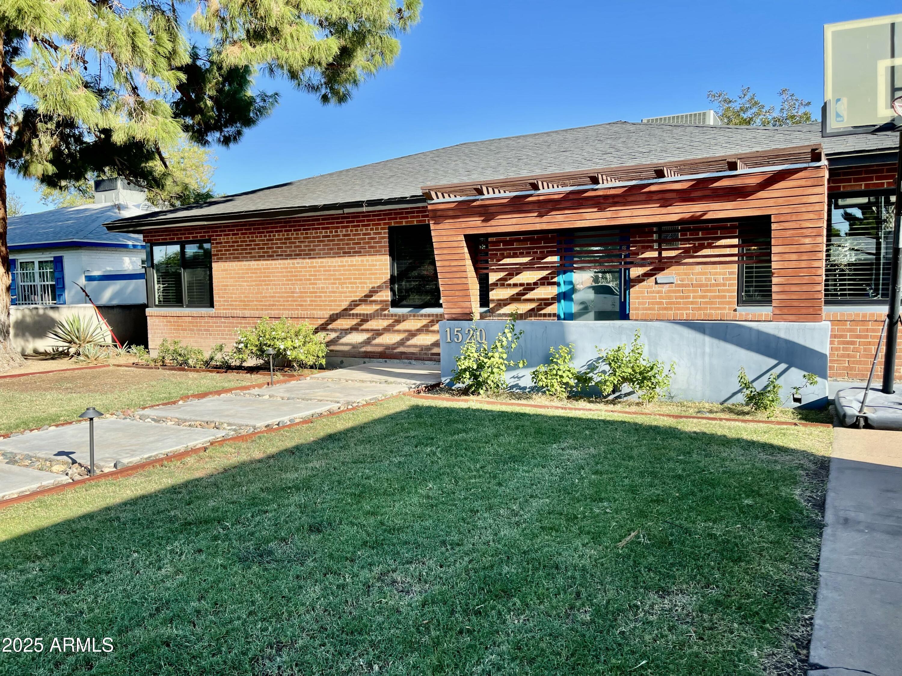 1520 West Berridge Lane Phoenix, AZ 85015 - Photo 6 of 46 a front view of a house with garden