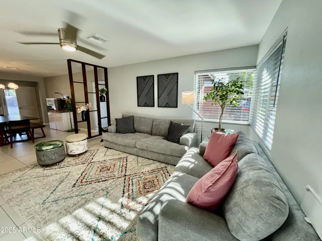 a living room with furniture and a potted plant