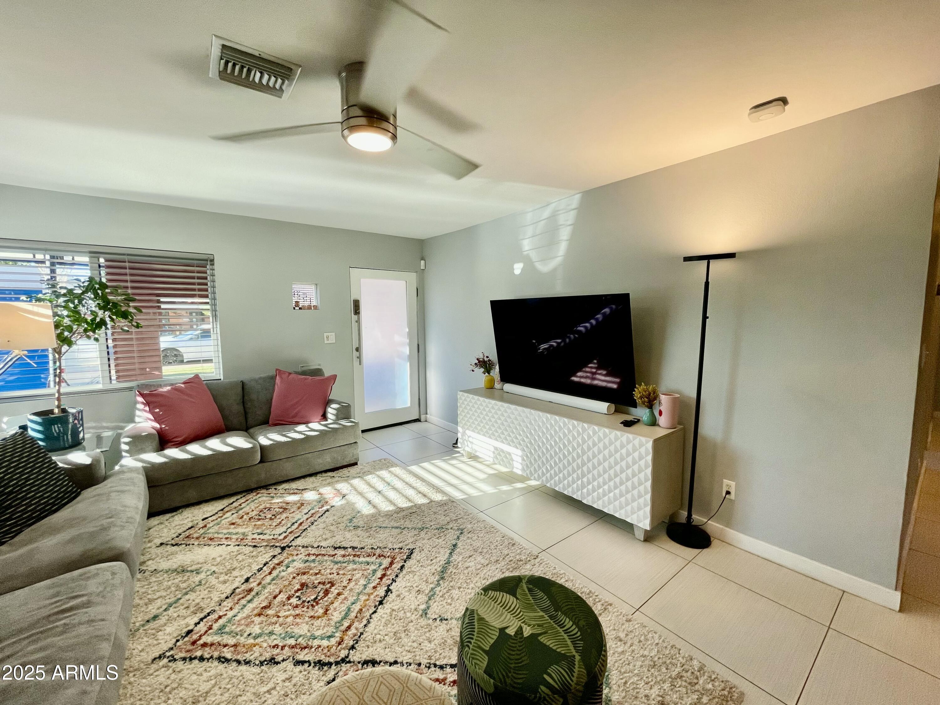 1520 West Berridge Lane Phoenix, AZ 85015 - Photo 10 of 46 a living room with furniture and a flat screen tv