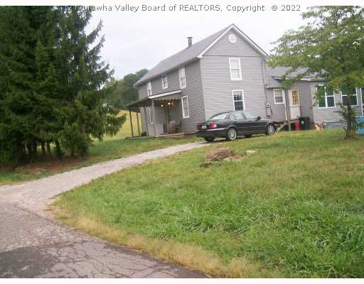 414 Peach Ridge Road Hurricane, WV 25526 - Photo 5 of 8 Exterior Front. Taken from righe side.Pine trees in front. Gravel drive but blacktop road.