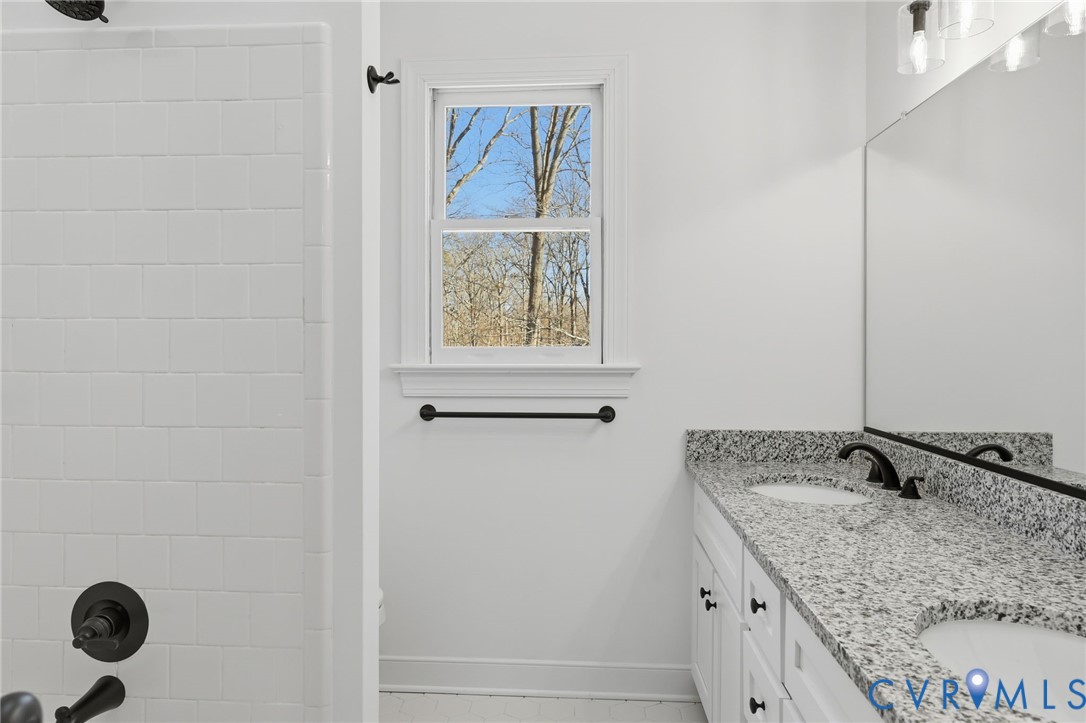 3264 Sherwood Ridge Way Powhatan, VA 23139 - Photo 21 of 40 a bathroom with a granite countertop sink and a window