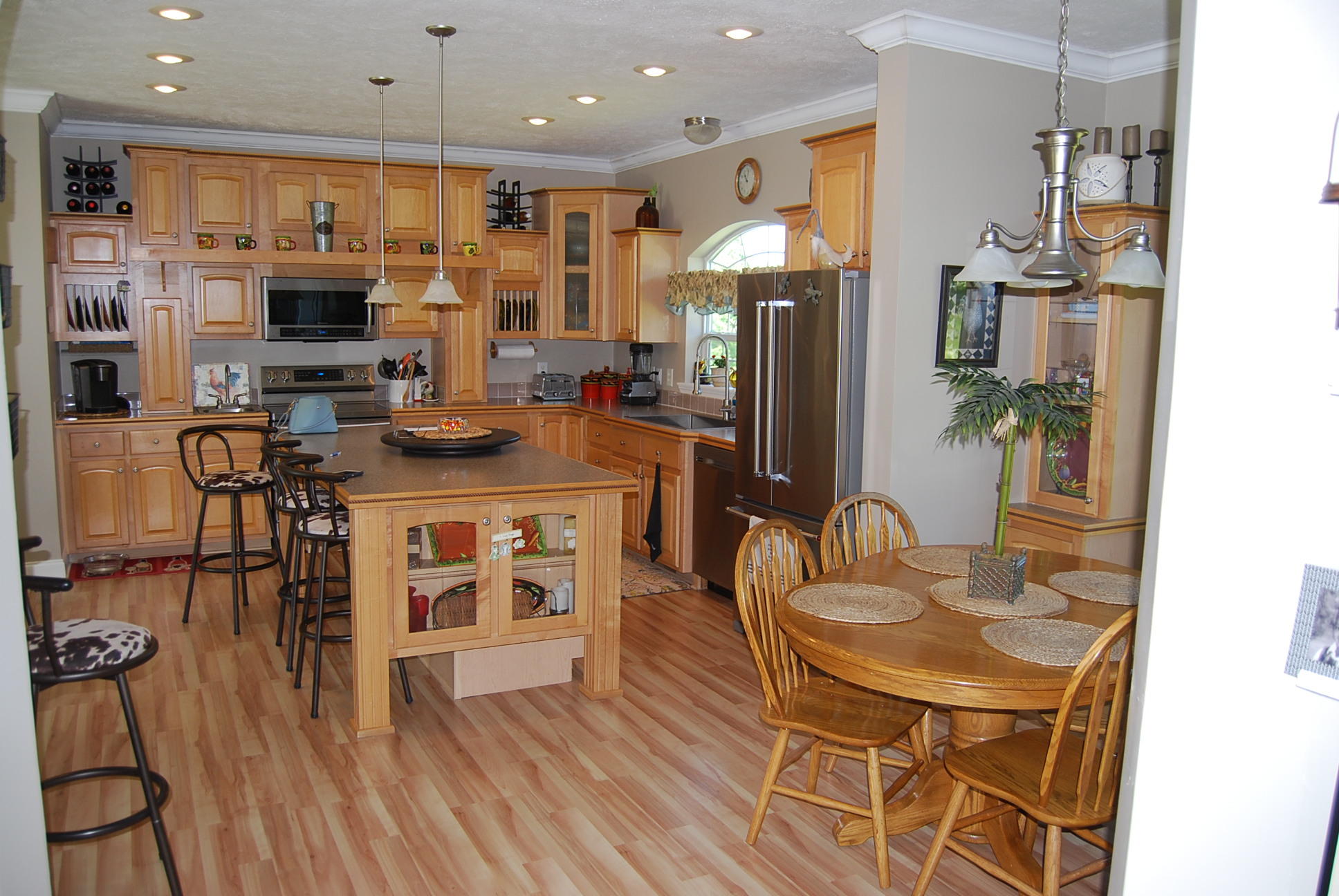 2342 Dillards Hill Road Union Hall, VA 24176 - Photo 27 of 51 a kitchen with stainless steel appliances granite countertop a stove a refrigerator a kitchen island a dining table and chairs with wooden floor