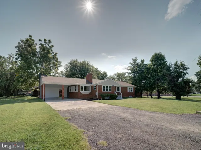 a view of house with yard outdoor seating and green space