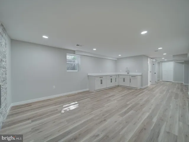 a view of a kitchen with white cabinets