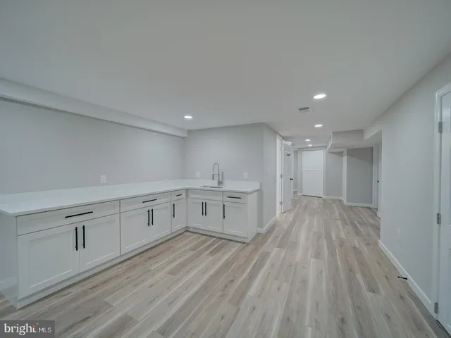 a bathroom with a toilet sink vanity and mirror